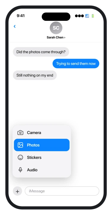 The iOS 26 Messages plus menu open, showing Camera and Photos options
