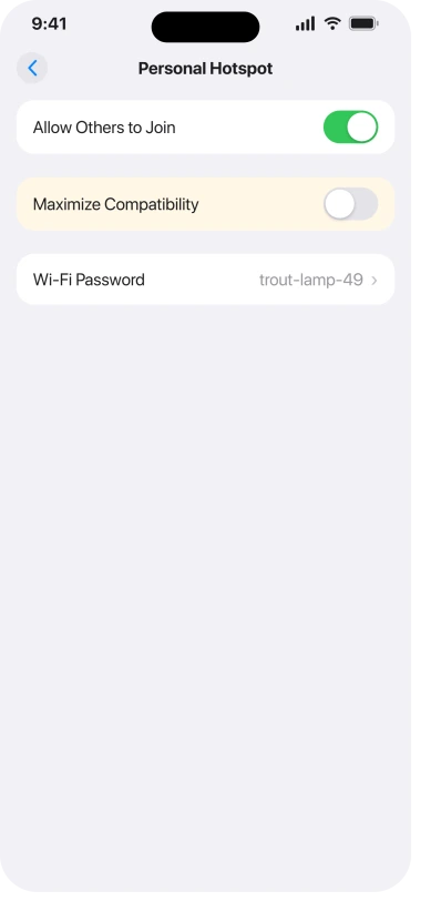 The Personal Hotspot screen in iOS 26 Settings with Allow Others to Join switched on and Maximize Compatibility switched off, alongside the Wi-Fi Password row
