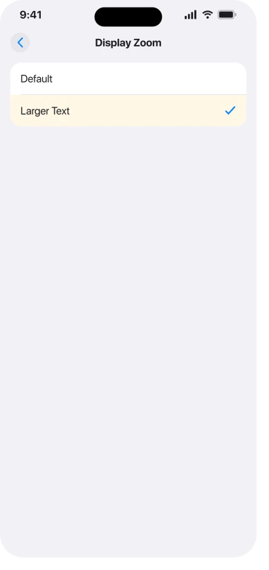 The Display Zoom screen in iOS 26 Settings, Display and Brightness, with Larger Text picked instead of Default, which is the choice that enlarges the keyboard along with everything else