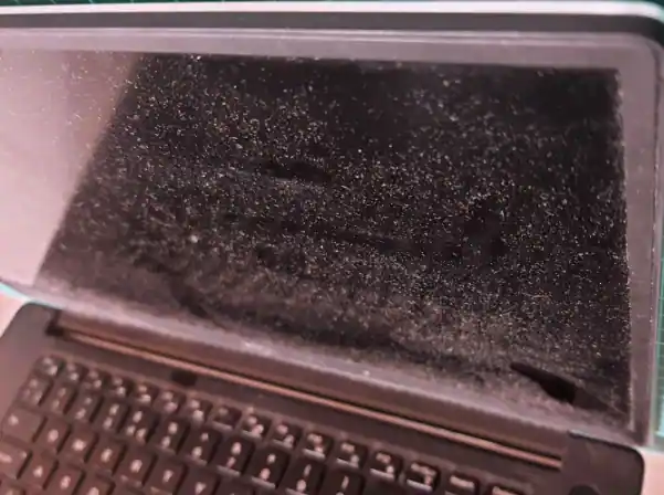 Dirt and Debris on laptop Screen Causing black spot